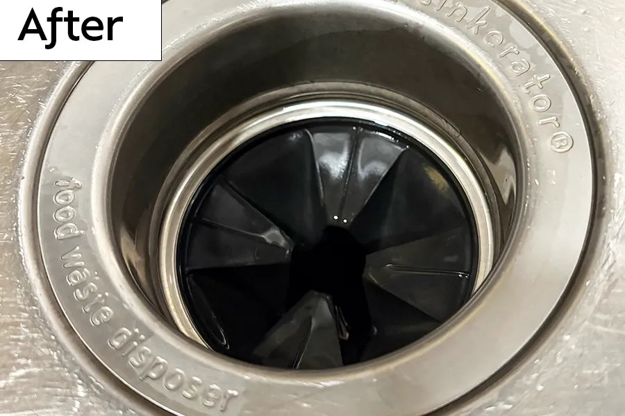 Kitchen sink garbage disposal drain with rubber splash guard that is shiny and clean and labeled 'After' 