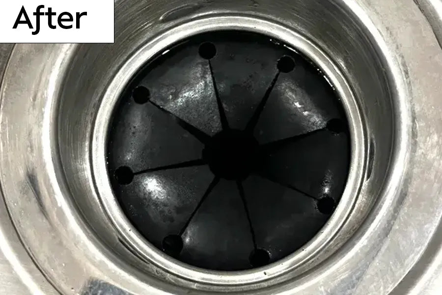 Kitchen sink garbage disposal drain with rubber splash guard that is shiny and clean and labeled 'After' 