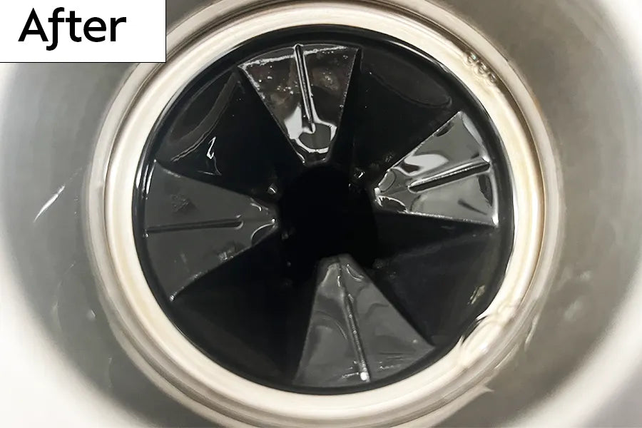 Kitchen sink garbage disposal drain with rubber splash guard that is shiny and clean and labeled 'After' 